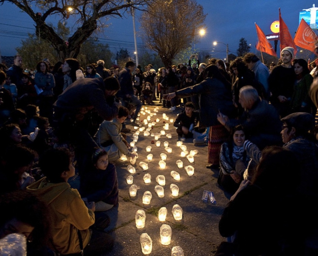 14. People light candles gates National Stadium Santiago Sept. 11th.jpg